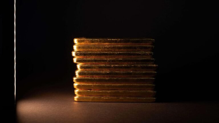 Gold bars and uk stock market graph